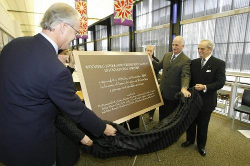 John Woods / Winnipeg Free Press /December 12, 2006 - 061212  - On  Sunday Dec 12/06 at the Winnipeg International Airport (LtoR) Hartley Richardson, Carolyn Hursh, grand children of James Richardson, Vic Toews, Minister of Justice, and Arthur Mauro, chair of the Winnipeg Airport Authority unveil a plaque at a press conference to announce that the airport will now be named the Winnipeg James Armstrong Richardson International Airport.