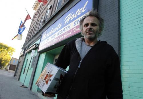 The New Merchants Hotel might close story. Rob Gurniak with a case of beer for his neighbour. Sept. 18, 2011 (BORIS MINKEVICH / WINNIPEG FREE PRESS)