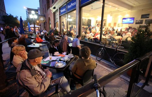 Overflow, participants watch from the patio at the Free Press News Cafe, as political candidates debate the state of housing in Manitoba, See Carol Sander's tale.....Sept19,2011 (Phil Hossack / Winnipeg Free Press)