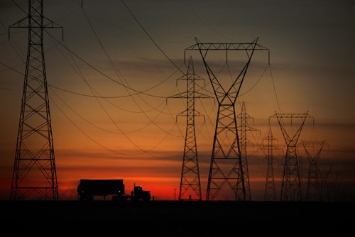 A truck passes some power transmission lines  and a sunset on the northwest perimeter in Winnipeg Thursday, September 22, 2011. (John Woods/Winnipeg Free Press