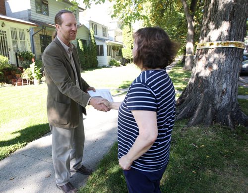MLA  Rob Altemeyer does some door to door campaigning in Wolseley Monday afternoon and stops to chat with Pamela Johnson- See Bart Kives story  September 25, 2011   (JOE BRYKSA / WINNIPEG FREE PRESS)