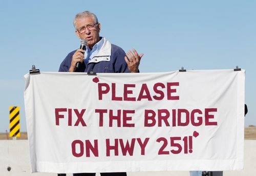 Brandon Sun 27092011 Arthur-Virden Conservative candidate Larry Maguire speaks during a rally on the east side of the washed-out Highway 251 bridge over the Souris river east of Coulter, Manitoba on Tuesday morning. Area residents, farmers and workers gathered to demand action on fixing the bridge from various levels of government. (Tim Smith/Brandon Sun)
