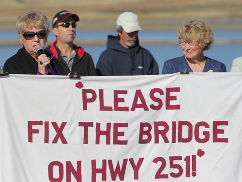 Brandon Sun 27092011 Rally organizers Betty Miller and Shirley Kernaghan speak during a rally on the east side of the washed-out Highway 251 bridge over the Souris river east of Coulter, Manitoba on Tuesday morning. Area residents, farmers and workers gathered to demand action on fixing the bridge from various levels of government. (Tim Smith/Brandon Sun)
