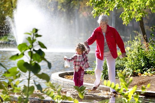 Two and a half year old Kara Rhodes and her grandmother Myra Rhodes are all smiles as they make their way across a bridge made of stones while feeding the ducks on the pond at Assiniboine Park  Friday morning. Standup photo. Sept 27, 2011 Ruth Bonneville  Winnipeg Free Press