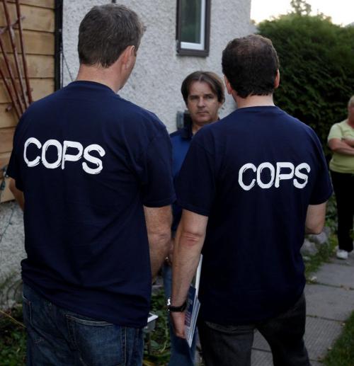 ELECTION - Hugh McFadyen,right, and St. Vital PC candidate Mike Brown,left, work the streets in St. Vital. Here they show their police endorsement t shirts as they talk to resident Harold Rivard.  Oct. 3, 2011 (BORIS MINKEVICH / WINNIPEG FREE PRESS)