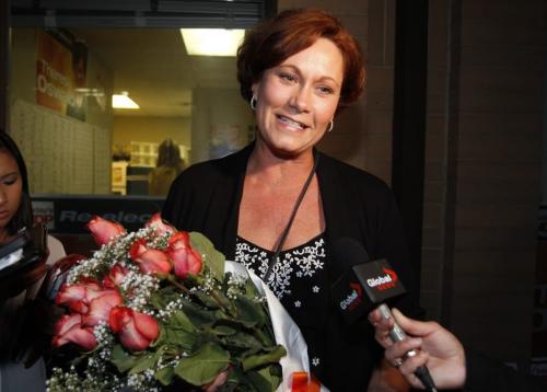 MANITOBA ELECTION 2011 - NDP Theresa Oswald holds a bouquet of roses while being interviewed by local media in front of her Seine River riding office at 1-1549 St. Marys Road. She won over ex city councillor Gord Steeves.  Oct. 4, 2011 (BORIS MINKEVICH / WINNIPEG FREE PRESS)