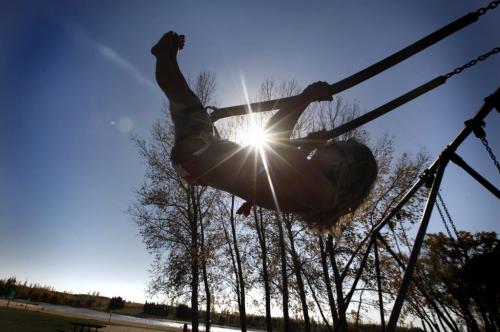 Jacky Boulloigne swings into the brillentt sunshine at Birds Hill Park Wednesday while taking advantage of the weather to go to the beach with a friend.   See story by Melissa Martin  Oct 05, 2011 Ruth Bonneville  Winnipeg Free Press