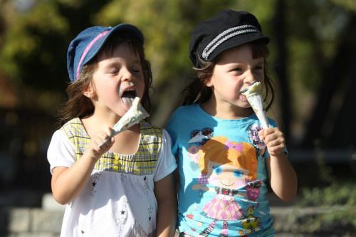 Identical four year old twins Ashley (white shirt)  and Julia  Gidilewich, enjoy some ice cream from Sargent Sundae Wednesday afternoon while hanging out with dad. See story by Melissa Martin  Oct 05, 2011 Ruth Bonneville  Winnipeg Free Press