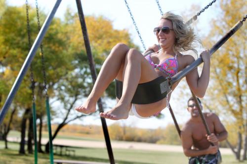 Jacky Boulloigne swings into the brillentt sunshine at Birds Hill Park Wednesday while taking advantage of the weather to go to the beach with her friend Colin Boulloigne. See story by Melissa Martin  Oct 05, 2011 Ruth Bonneville  Winnipeg Free Press