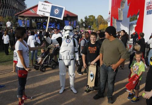 NHL Faceoff 2011 at the Forks. A Stormtrooper poses with people at the Forks. The Imperial Stormtroopers are fictional soldiers from George Lucas' Star Wars universe.  Oct. 6, 2011 (BORIS MINKEVICH / WINNIPEG FREE PRESS)