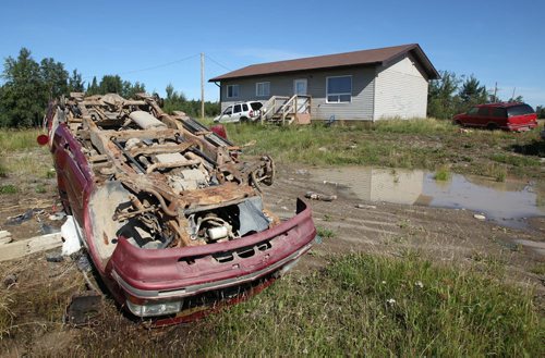 Over turned car in a front yard in St. Theresa Point First Nation- See Mary Agnes No Running Water Feature  August 17, 2011   (JOE BRYKSA / WINNIPEG FREE PRESS)