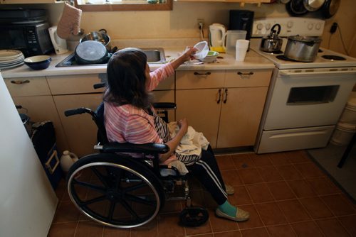 Rubena Thomas does her dishes by hand from her wheel chair in her home in Wasagamack First Nation.  She lives in a home with no running water- See Mary Agnes No Running Water Feature  August 18, 2011   (JOE BRYKSA / WINNIPEG FREE PRESS)