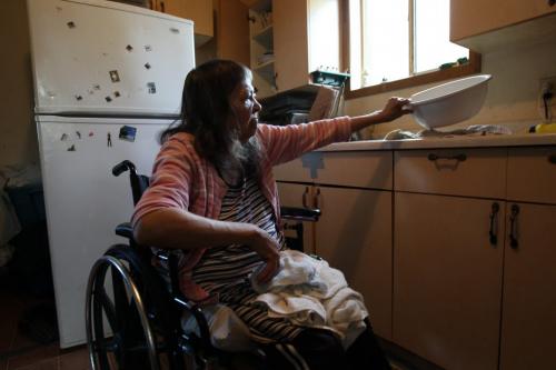 Rubena Thomas does her dishes by hand from her wheel chair in her home in Wasagamack First Nation.  She lives in a home with no running water- See Mary Agnes No Running Water Feature  August 18, 2011   (JOE BRYKSA / WINNIPEG FREE PRESS)