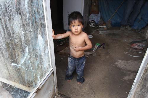 A child peers from the front doorway in the  trailer of Richard Andrews in Wasagamack First Nation.  It is in filthy condition, has mold and is overpopulated by over 13 people living inside. It has  no running water- See Mary Agnes No Running Water Feature  August 18, 2011   (JOE BRYKSA / WINNIPEG FREE PRESS)