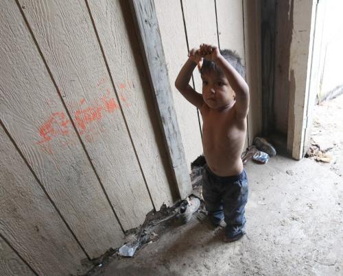 A child in the front doorway in the  trailer of Richard Andrews in Wasagamack First Nation.  It is in filthy condition, has mold and is overpopulated by over 13 people living inside. It has  no running water- See Mary Agnes No Running Water Feature  August 18, 2011   (JOE BRYKSA / WINNIPEG FREE PRESS)