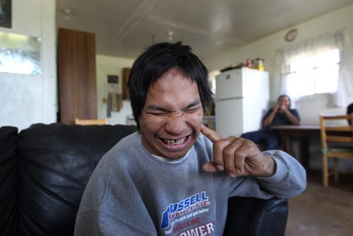 30 year old Kevin Taylor who has Cerebral palsy smiles inside his home in St Theresa Point First Nation- His mother Alice has filled a Human Rights  to  get proper services for her son on the reservation. Their home has no running water- See Mary Agnes No Running Water Feature  August 19, 2011   (JOE BRYKSA / WINNIPEG FREE PRESS)