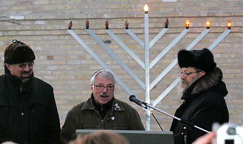 BORIS MINKEVICH / WINNIPEG FREE PRESS  061217 David Rich, centre,  leads in some songs with Dr. Edward Lyons,L, and Rabbi Avrohom Altein after lighting the 3rd light of the menorah at the Asper Jewish Community Campus.