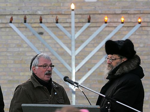 BORIS MINKEVICH / WINNIPEG FREE PRESS  061217 David Rich leads in some songs with Rabbi Avrohom Altein after lighting the 3rd light of the menorah at the Asper Jewish Community Campus.