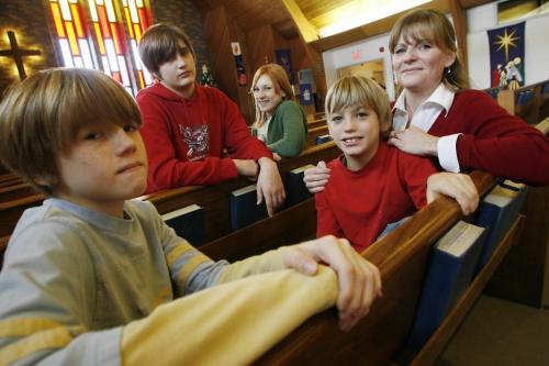 John Woods / Winnipeg Free Press / December 17, 2006 - 061217  - Rhonda Buck and her children (LtoR) Liam (11), Kai (15), Jensen (13), and Connor (9) sit in St James Lutheran Church Sunday Dec 17/06.   Buck's husband Rod, who is the pastor of the church, is also a reservist and is currently a military chaplain in Afghanistan.