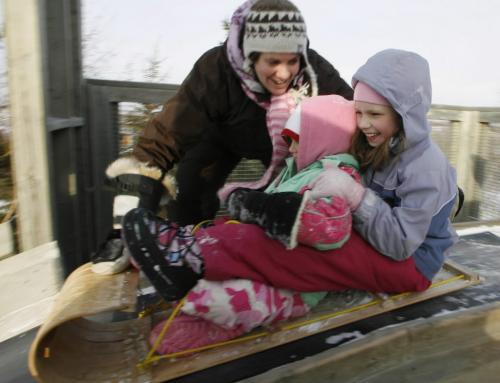 John Woods / Winnipeg Free Press / December 17, 2006 - 061217 - Michelle McCormick pushes Jennessa Gruenke (L) and Taylor Kachmar (R) down the toboggan slide at the Fort White Centre Sunday Dec 17/06.