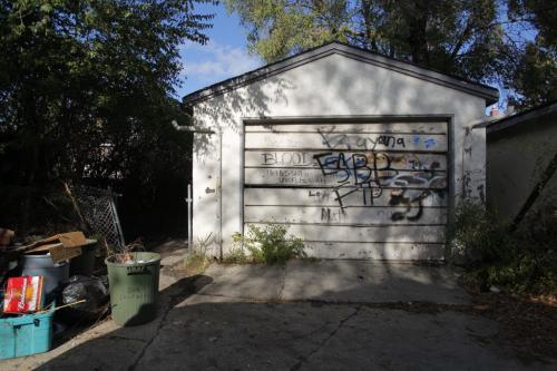 Union Ave. W 300 block. The rear of 318. NOTE FUCK AND OTHER PROFANITIES ON THE GARAGE DOOR. WARNING.   Oct. 23, 2011 (BORIS MINKEVICH / WINNIPEG FREE PRESS)