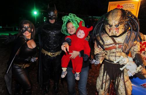 Boo at the Zoo standup photo. Jodene Monkman with her son Raymond pose for a photo with folks dressed up as comic book characters.  Oct. 23, 2011 (BORIS MINKEVICH / WINNIPEG FREE PRESS)
