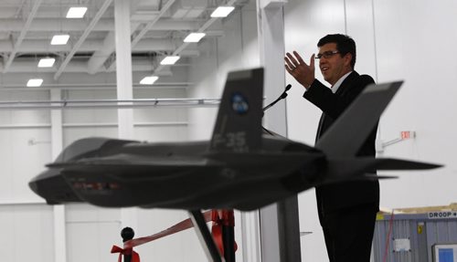In pic Don Boitson VP and GM of Magellan Aerospace  introduces  Julian Fantinio Associate Minister of Defence ,  participates in the official opening of Magellan lAerospacenew Advanced Composites Manufacturing Centre. This facility will manufacture parts and assemble the horizontal tail structures for the F-35 Lightning II aircraft. Model of the F35 is in foreground  KEN GIGLIOTTI / WINNIPEG FREE PRESS /  Oct 25 2011