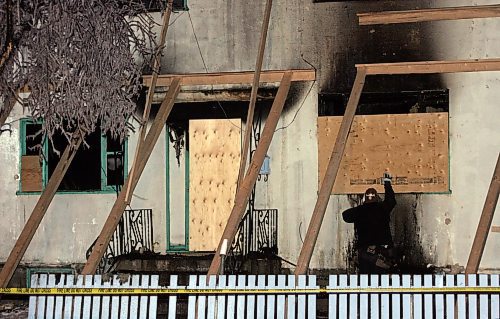 BORIS MINKEVICH / WINNIPEG FREE PRESS  061221 Winnipeg Builders board up the house that burnt early this morning on Elgin.