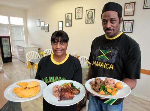Eveth Smalling, Owner, and Easton Sproul, Chef, in the Island Flava restaurant on Dufferin. They are holding (l-r) Jamaican patties, Jerk Chicken and Oxtail.  111027 Mike Deal / Winnipeg Free Press