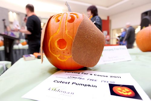 Free Press columnist Doug Speirs is awarded the "Cutest Pumpkin" certificate for his carving of his dog at the Kildonan Place Annual Pumpkin Carving Contest Friday. Oct 28,2011 (Ruth Bonneville /  Winnipeg Free Press)