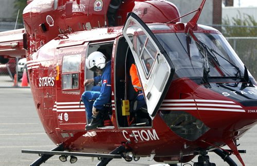 Domhnall O'Dochartaigh R.N. climbs out of the STARS air ambulance based in Winnipeg after landing on the parking lot of the Victoria Hotel in Winnipeg Friday as part of the provincial EMS conference InterAct 2011 as a sponsor and providing an education session. By participating in the conference the staff of the fully equipped emergency ambulance will become even more familiar with Manitoba's chain of survival to work together to provide rapid care and  transportation to critically ill and injured patients.     see release. (WAYNE GLOWACKI/WINNIPEG FREE PRESS) Winnipeg Free Press Oct. 28 2011