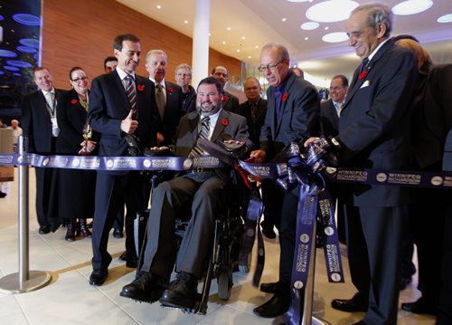 The new Winnipeg James Armstrong Richardson International Airport opens officially with a special ribbon cutting in the arrivals area. Left to right in the centre starting with WAA Board Chairman Tom Bryk (thumbs up), over his left shoulder Barry Rempel President and Chief Executive Officer WAA, MP Steven Fletcher, Mayor Sam Katz, and Aurthur Mauro.   Oct. 30, 2011 (BORIS MINKEVICH / WINNIPEG FREE PRESS) James Richardson International Airport.