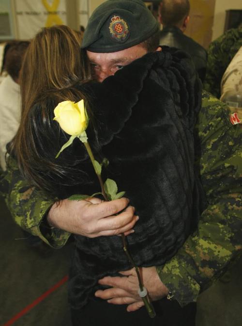 John Woods / Winnipeg Free Press / December 23, 2006 - 061223  - Cpl. Daniel Morin is welcomed home by his excited wife Nancy Gingras in the arrival area of 17th Wing Saturday Dec. 24/06.  Fifty three soldiers arrived back from the secret Camp Mirage which supports troupes in Afghanistan.