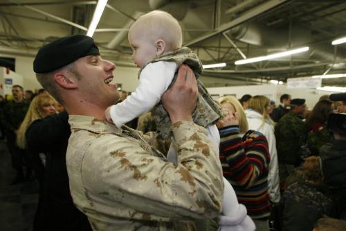 John Woods / Winnipeg Free Press / December 23, 2006 - 061223  - Cpl. Bryce Hooper raises his daughter Madison in the arrival area of 17th Wing Saturday Dec. 24/06.  Fifty three soldiers arrived back from the secret Camp Mirage which supports troupes in Afghanistan.