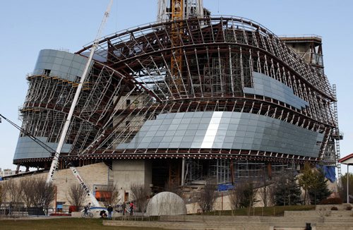 Weather Stdup - Construction update  The Canadian Museum for Human Rights  is nearly  closed in with glass panels  as passerby's enjoy the warm fall day  at the  skate board park at the Forks - update for book project - MFHR  - KEN GIGLIOTTI /  WINNIPEG FREE PRESS /  Oct 31 2011 CMHR