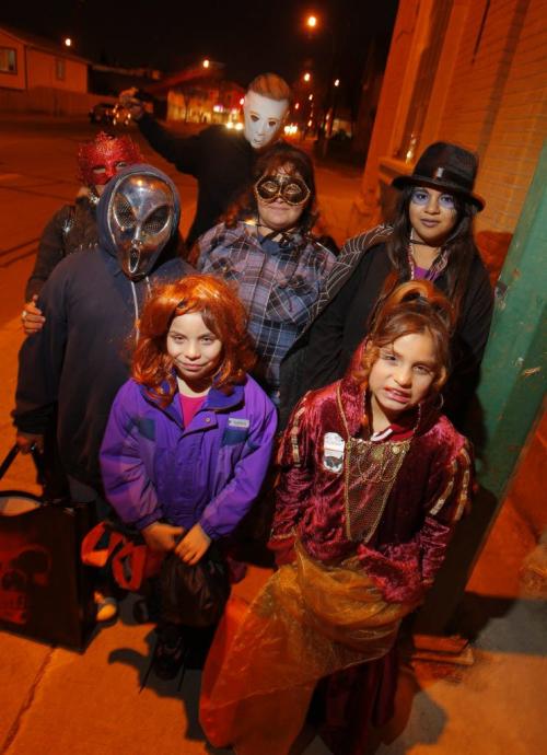 Halloween in the North End. Trick or treaters. front-Freedom and Jerri-Lynn, back left to right- Brandi(red mask), Brandon(alien), Candace, Danielle(black top hat), and behind slasher named DJ. All have the last name Genaille. Oct. 31, 2011 (BORIS MINKEVICH / WINNIPEG FREE PRESS)