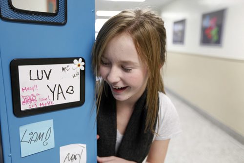 Grade 7 WIndsor School student Sydney looks at her stickers on the inside of her locker made by her classmates. This is the first year that the students are given the independance of their own lockers, moving to different rooms between classes and taking the transit bus on their own to name a few.  See 2017 project, Carolin Vesley and Doug Speirs Nov 10,2011 (Ruth Bonneville /  Winnipeg Free Press)
