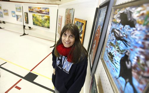 Visual artist Ildiko Nova shows off some of her paintings at the Art Show and Sale at the Community Centre at 430 Langside Street Saturday.  The art show titled "Art From The Heart" featured inner city and low income artists.  Nov 19,2011 (Ruth Bonneville /  Winnipeg Free Press)