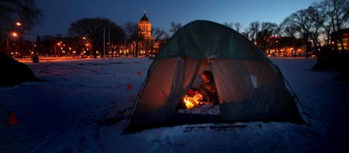 Howard Loesewitz keeps warm reading a paper in his tent at the Occupy Winnipeg site in Memorial Park next to the Provincial Legislature. See story. Novemebr 22, 2010 - (Phil Hossack / Winnipeg Free Press)