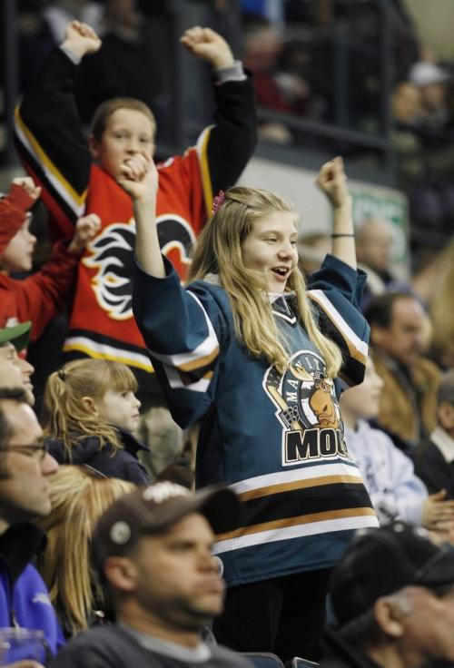 John Woods / Winnipeg Free Press / Dec 31, 2006 - 0611231  - Manitoba Moose fans Amy Muir (13) (f) and Ty Edmonds cheer on the team against the Syracuse Crunch Sunday Dec 31/06.     ***For fan feature***