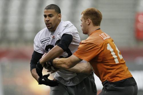 VANCOUVER, BC: NOVEMBER 26, 2011 --  BC Lions' Travis Lulay (14) hands off to Andrew Harris (33) during practice in Vancouver Saturday, November 26, 2011 ahead of the 2011 Grey Cup. (John Woods/Winnipeg Free Press)