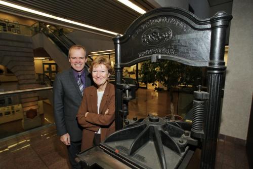 Winnipeg Free Press Publisher Bob Cox (left) and Editor Margo Goodhand (right) with an old letterpress that was used to print early copies of the Manitoba Free Press. 111129 Mike Deal / Winnipeg Free Press