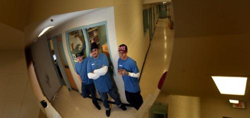 Stony Mountain inmates Jeremy Garton (29) (left) and  Lance Laquette (26) flank Fabian Twohearts as they joke with each other reflected in a hallway security mirror at Stoney Mountain penitentiary.  See Nick Martin's tale. (November 29, 2011) - (Phil Hossack / Winnipeg Free Press)