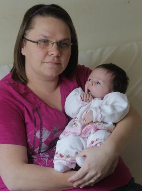 MONEY MATTERS - Mevanie Caners with her 3 week old daughter Leah Markham pose for a photo. November 30, 2011(BORIS MINKEVICH / WINNIPEG FREE PRESS)