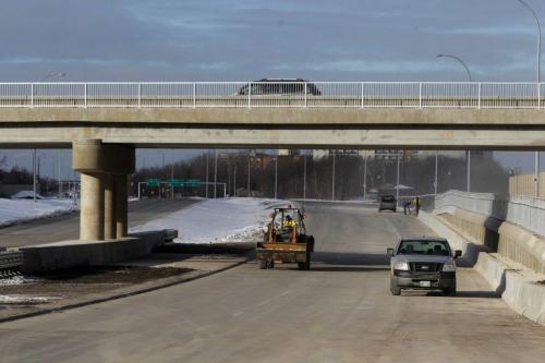 The extension of the Chief Peguis Bridge gets some final touches done to it by construction workers today. The road extends all the way to Lagimodiere Blvd. December 1, 2011(BORIS MINKEVICH / WINNIPEG FREE PRESS)