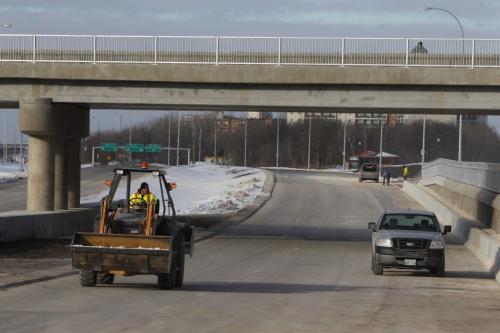 The extension of the Chief Peguis Bridge gets some final touches done to it by construction workers today. The road extends all the way to Lagimodiere Blvd. December 1, 2011(BORIS MINKEVICH / WINNIPEG FREE PRESS)
