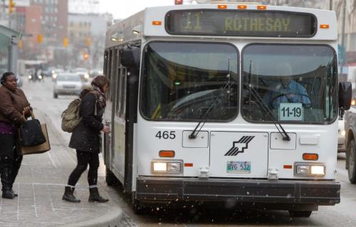 Bus passengers board a eastbound number eleven bus in front of the Bay downtown. December 1, 2011(BORIS MINKEVICH / WINNIPEG FREE PRESS)