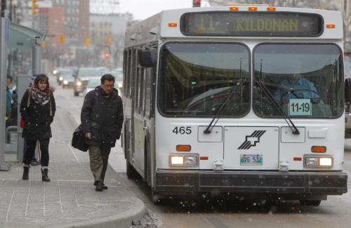 Bus passengers board a eastbound number eleven bus in front of the Bay downtown. December 1, 2011(BORIS MINKEVICH / WINNIPEG FREE PRESS)