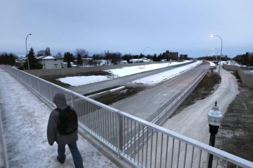 Pedestrians and vehicles travel across the Rothesay St. overpass that passes over the new Chief Peguis Trail extension that officially opens Friday. see story.   (WAYNE GLOWACKI/WINNIPEG FREE PRESS) Winnipeg Free Press Dec. 2 2011