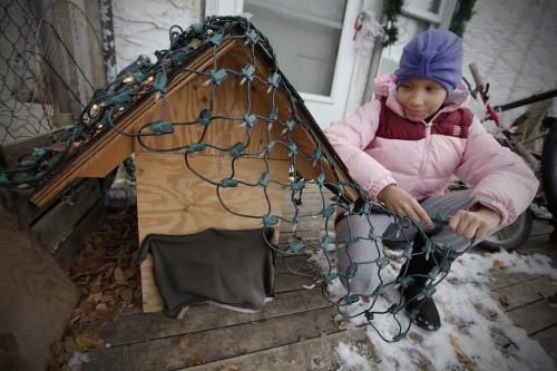 December 2, 2011 - 111202  -   Kara Belanger (9), who has cancer, puts lights on Candy's house Friday, December 2, 2011. Candy, her pet poodle,  was killed by the Humane Society who put him to sleep after her family couldn't care for the dog anymore. John Woods / Winnipeg Free Press